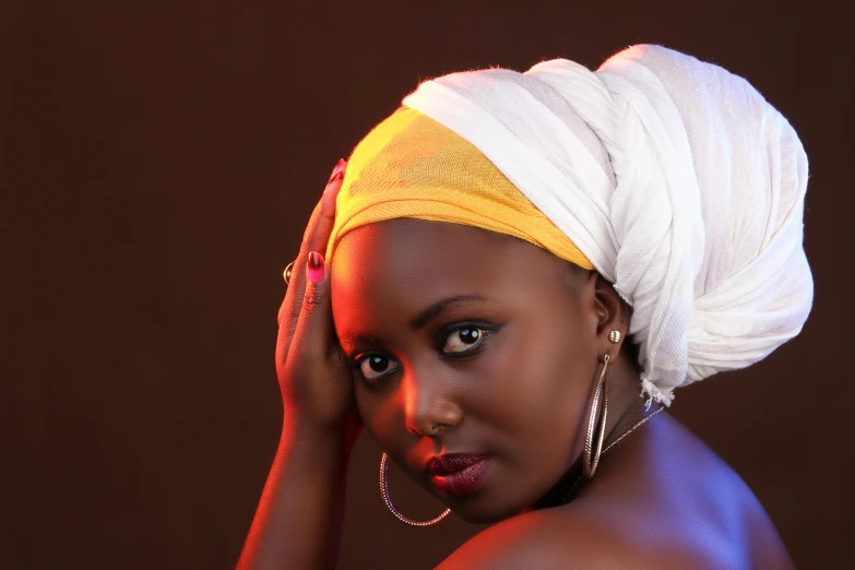 a woman with a towel on her head and earrings