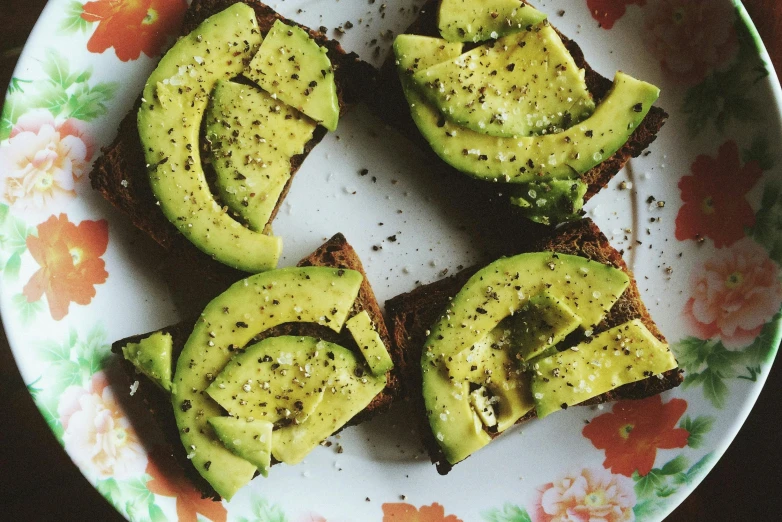 a plate full of toast and avocados cut in half