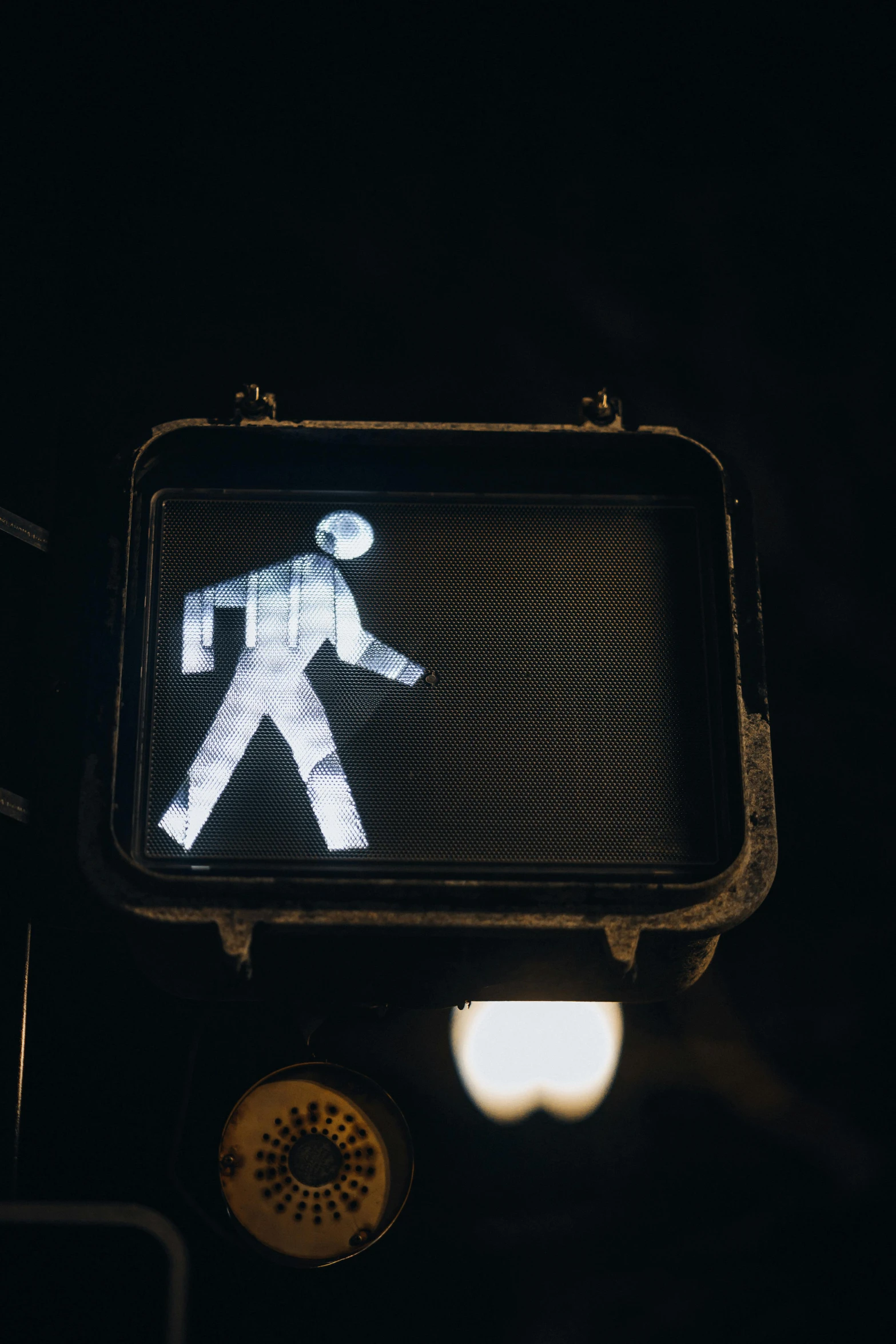 the back side of a traffic light with a person walking