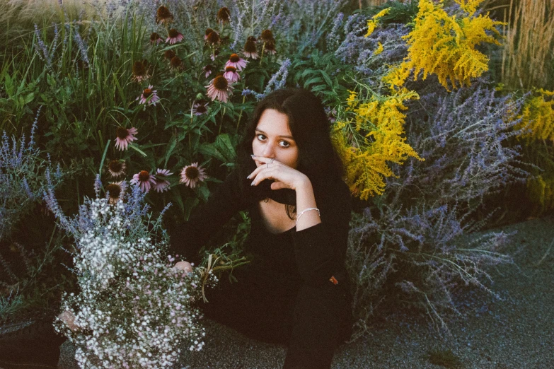 a girl posing in a field full of flowers