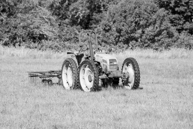 a tractor in a field, parked to the side of it