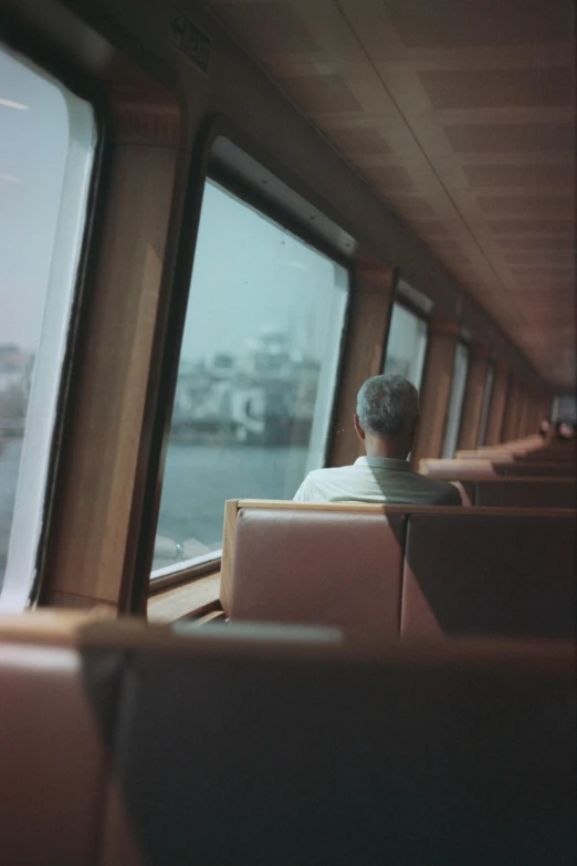 a man sitting on a train seat with other people