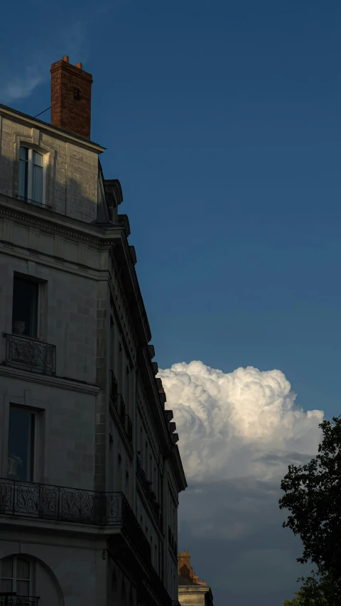 a building with some white clouds behind it