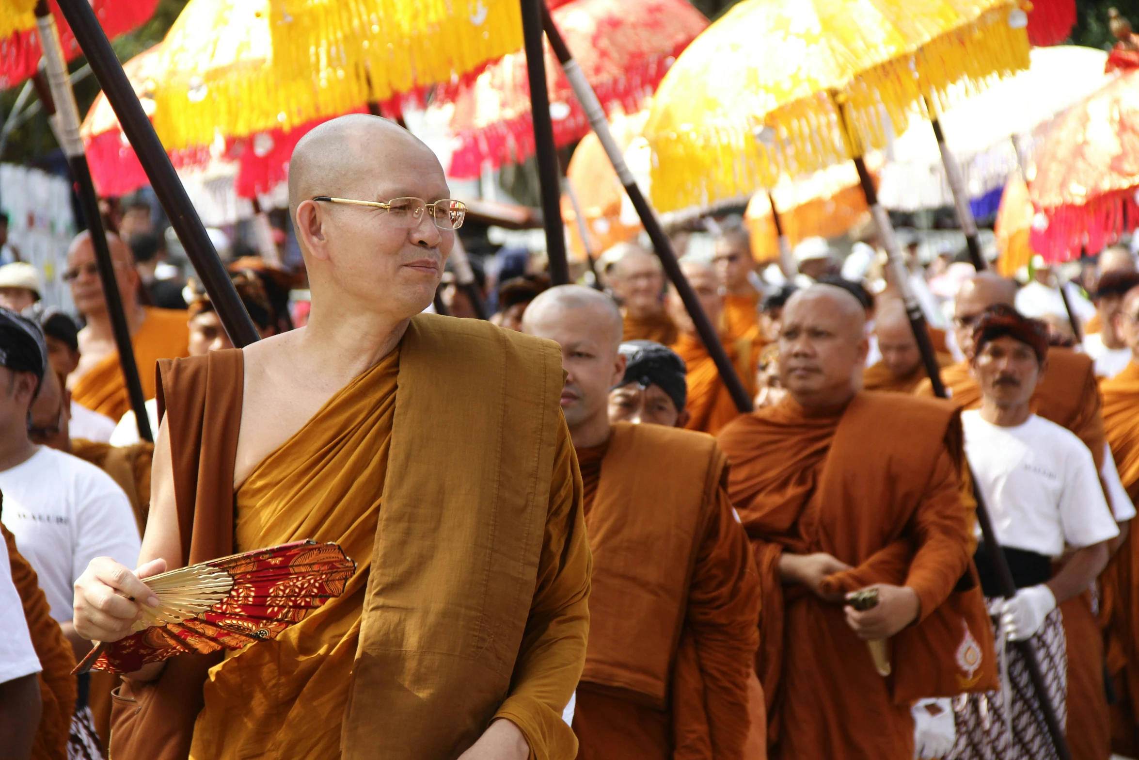 several men with orange robes and gold hair