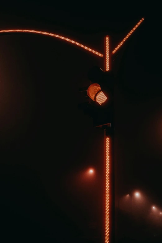 street light with red lights on it on a dark background