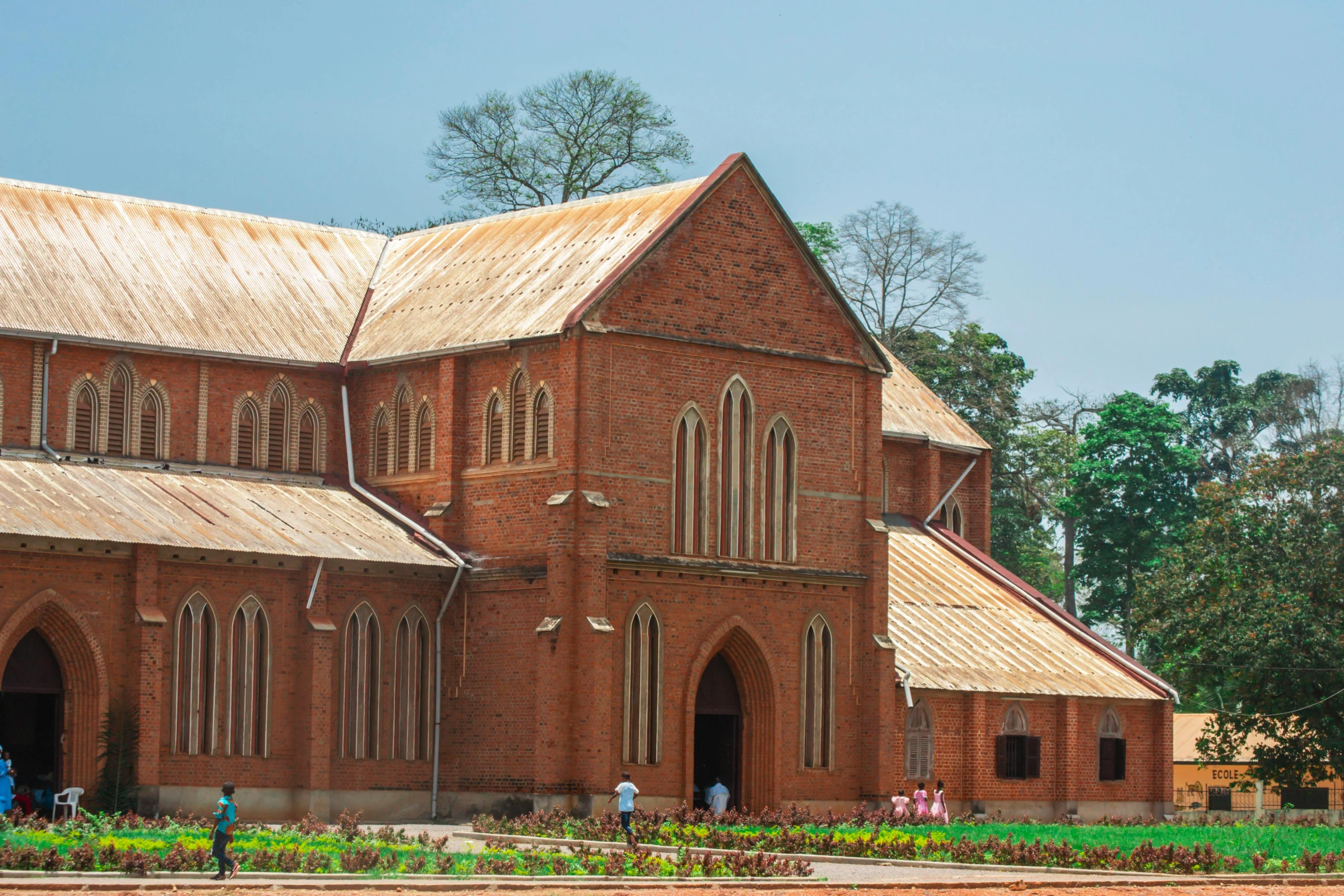 an old brick church in front of a park