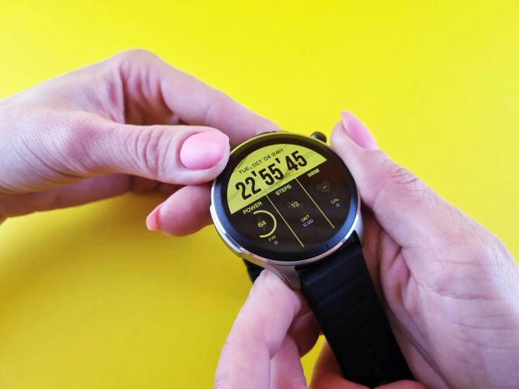 a close up of two hands holding a watch