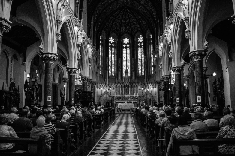 an ornate cathedral full of people looking up at the ceiling