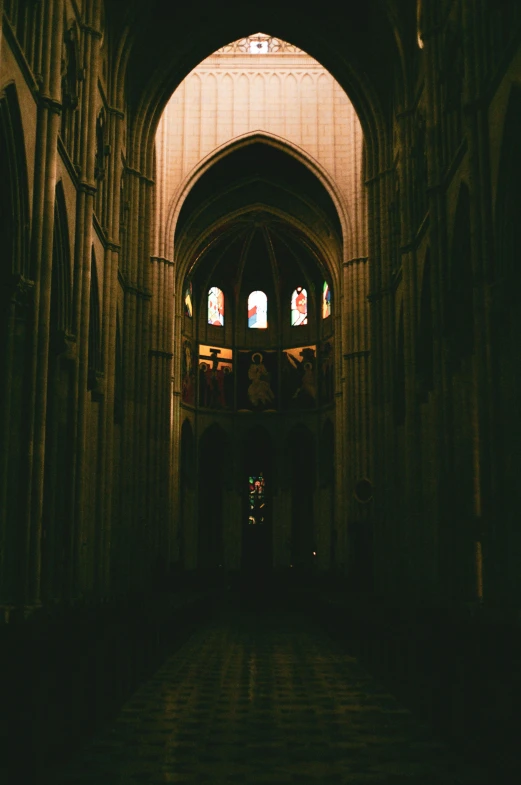 dark, cathedral room with stone floor and arches