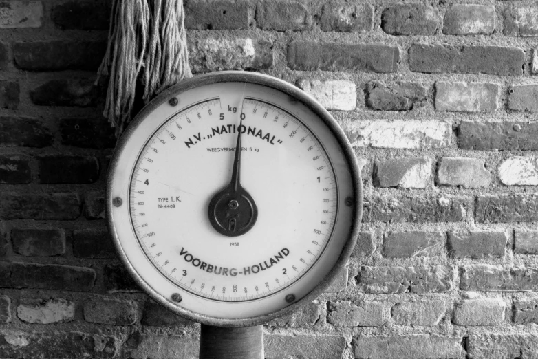 a black and white pograph of a barometer with the time passing