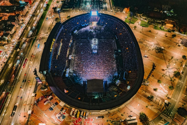 a very large stadium full of lots of people at night