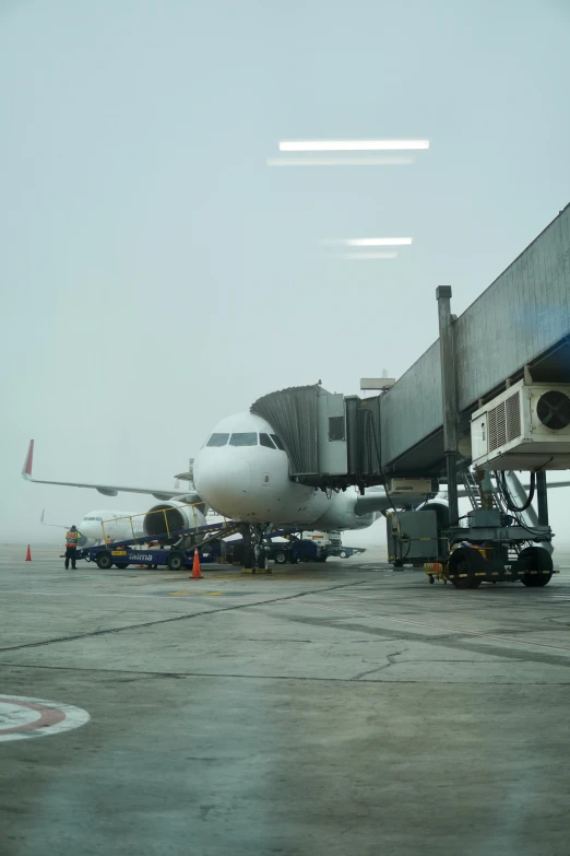 a passenger jet sitting on top of an airport runway