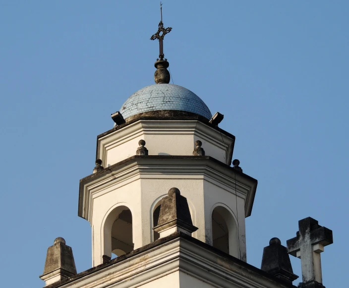 a white clock tower with a blue top