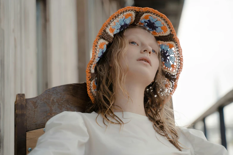 a  sitting with a hat on her head