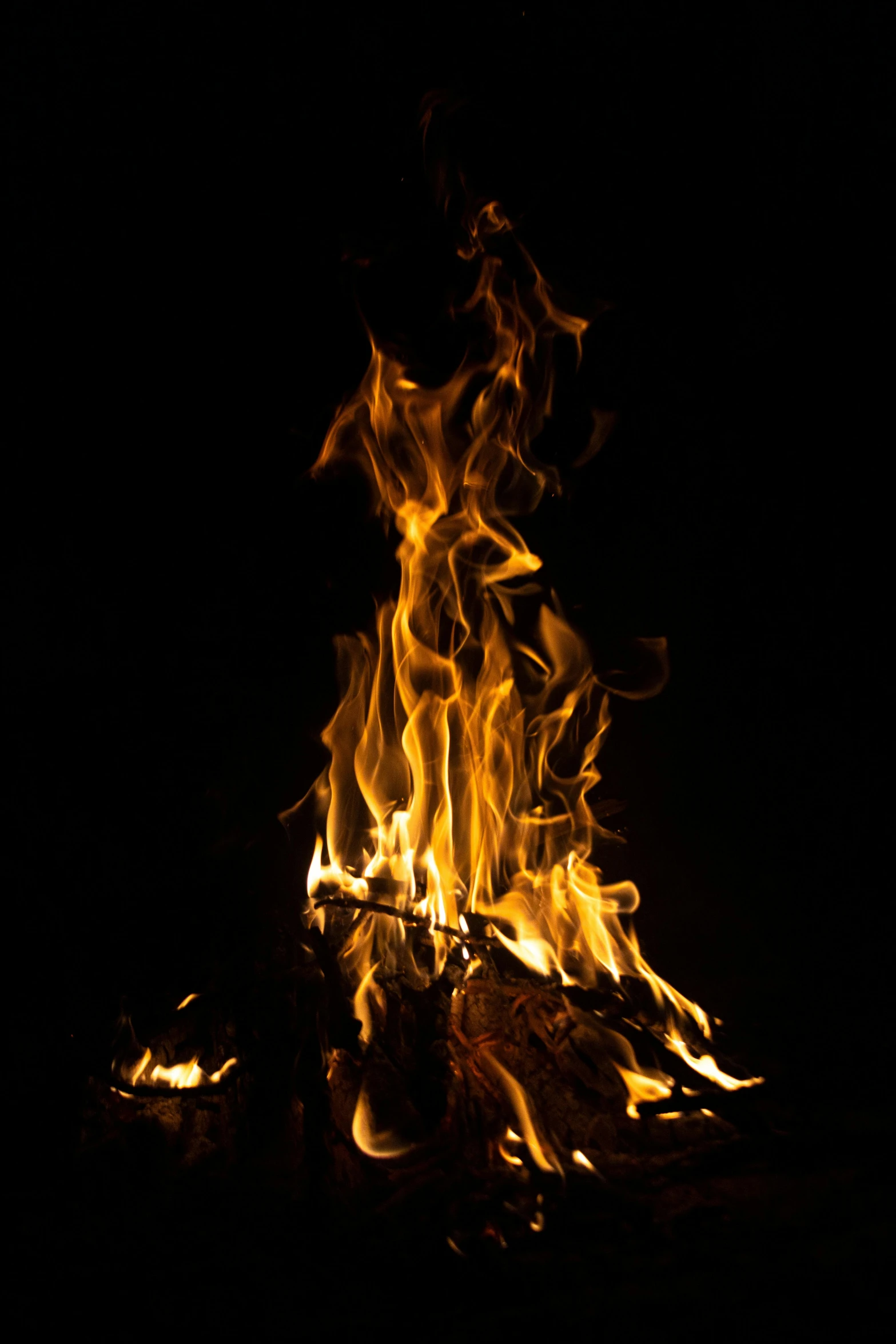 a close up of a fire burning in the dark