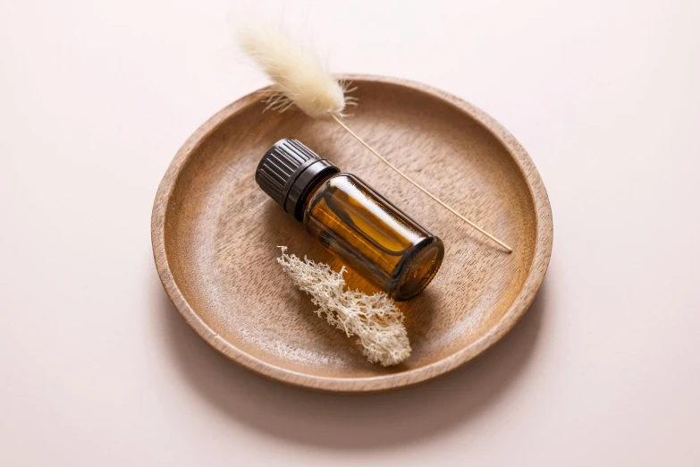 a close up of an essential oil bottle on a plate