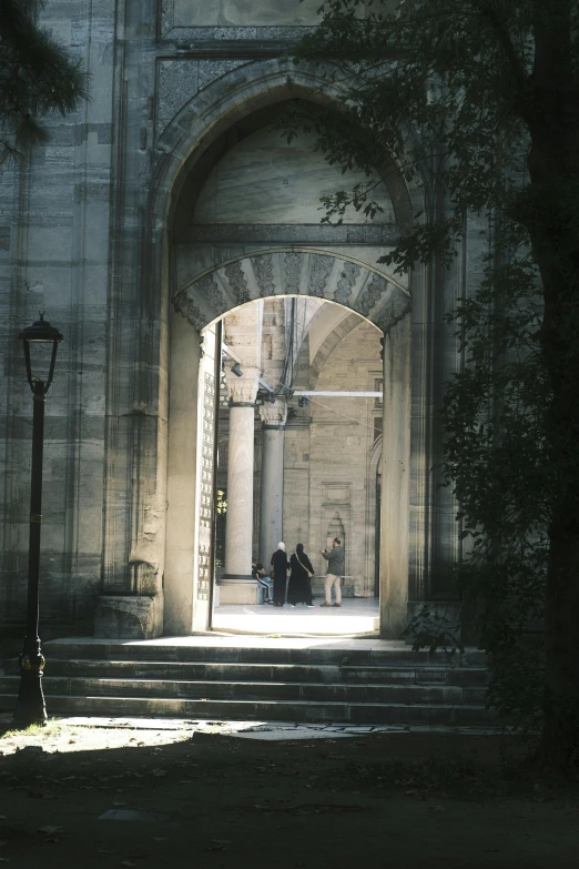 the view through the archway of an old building