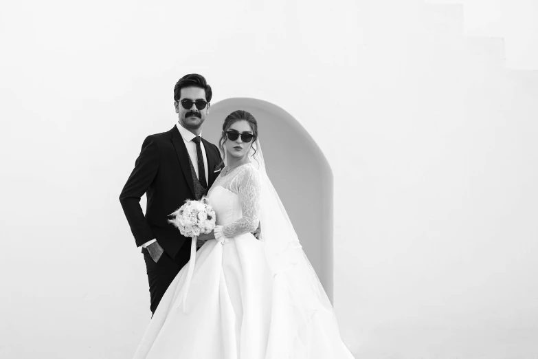 a man and woman posing with each other in wedding clothes