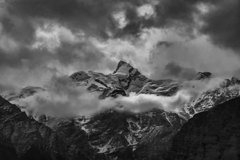 clouds blowing in the distance above a mountain range