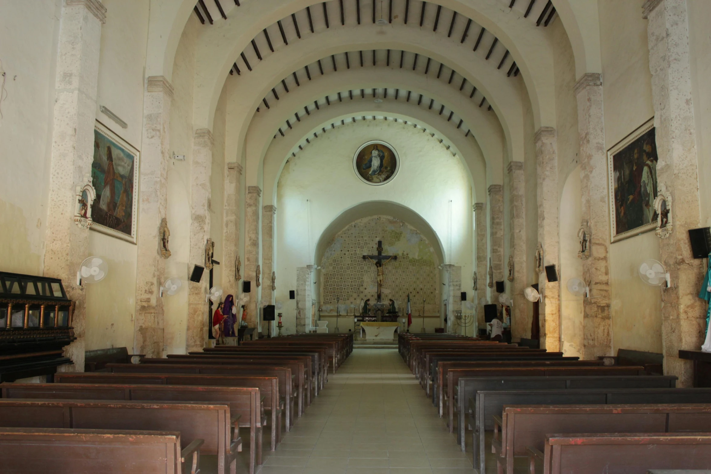 a picture inside of a church looking down the aisle