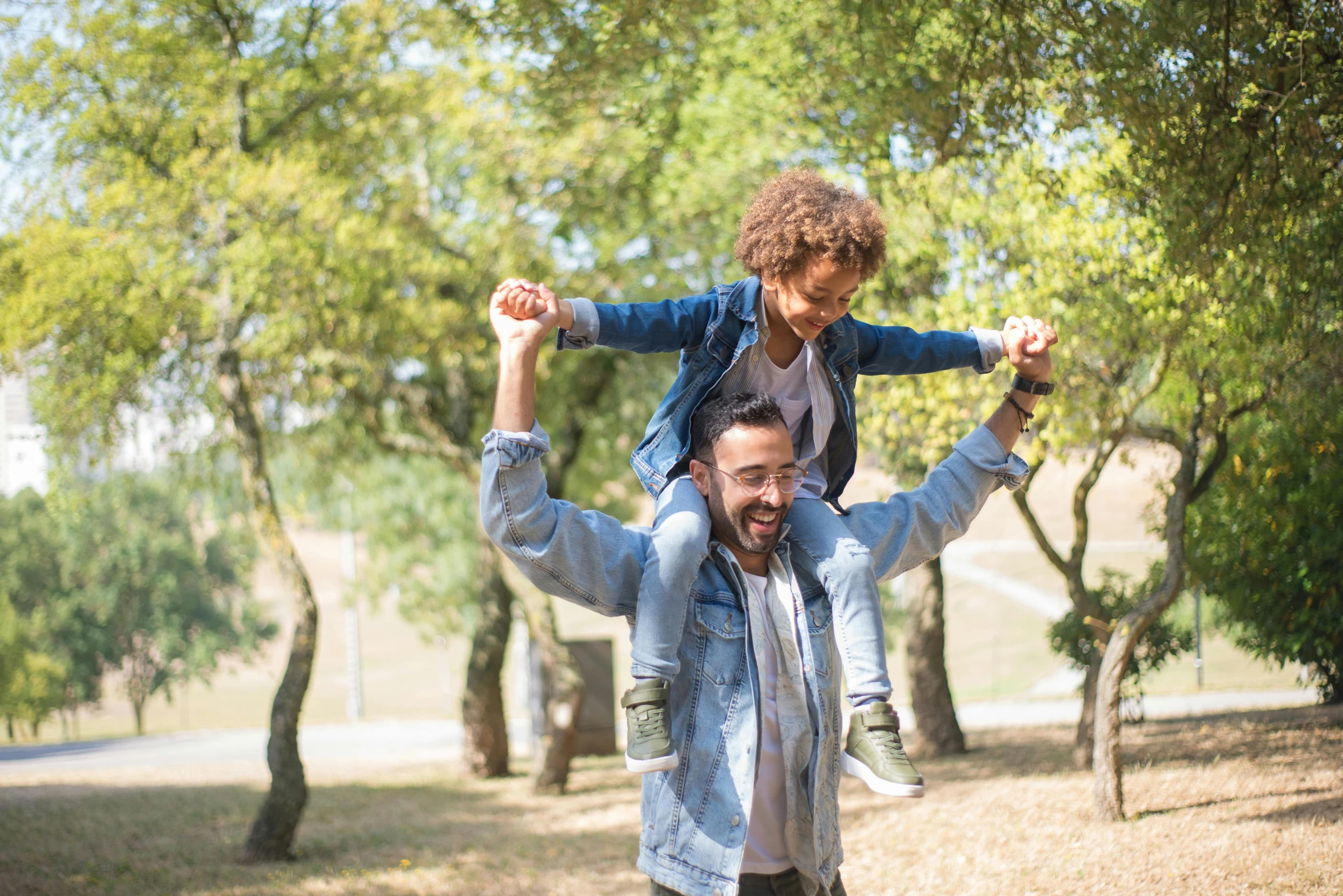 a young man carries his  on his shoulders