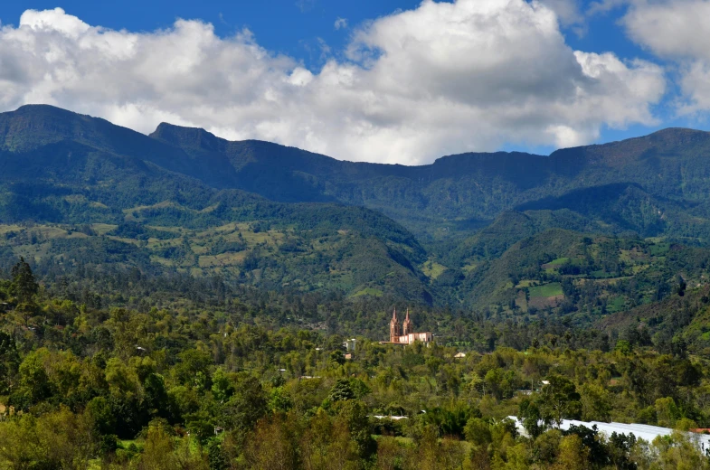 a mountain top with a house in the foreground