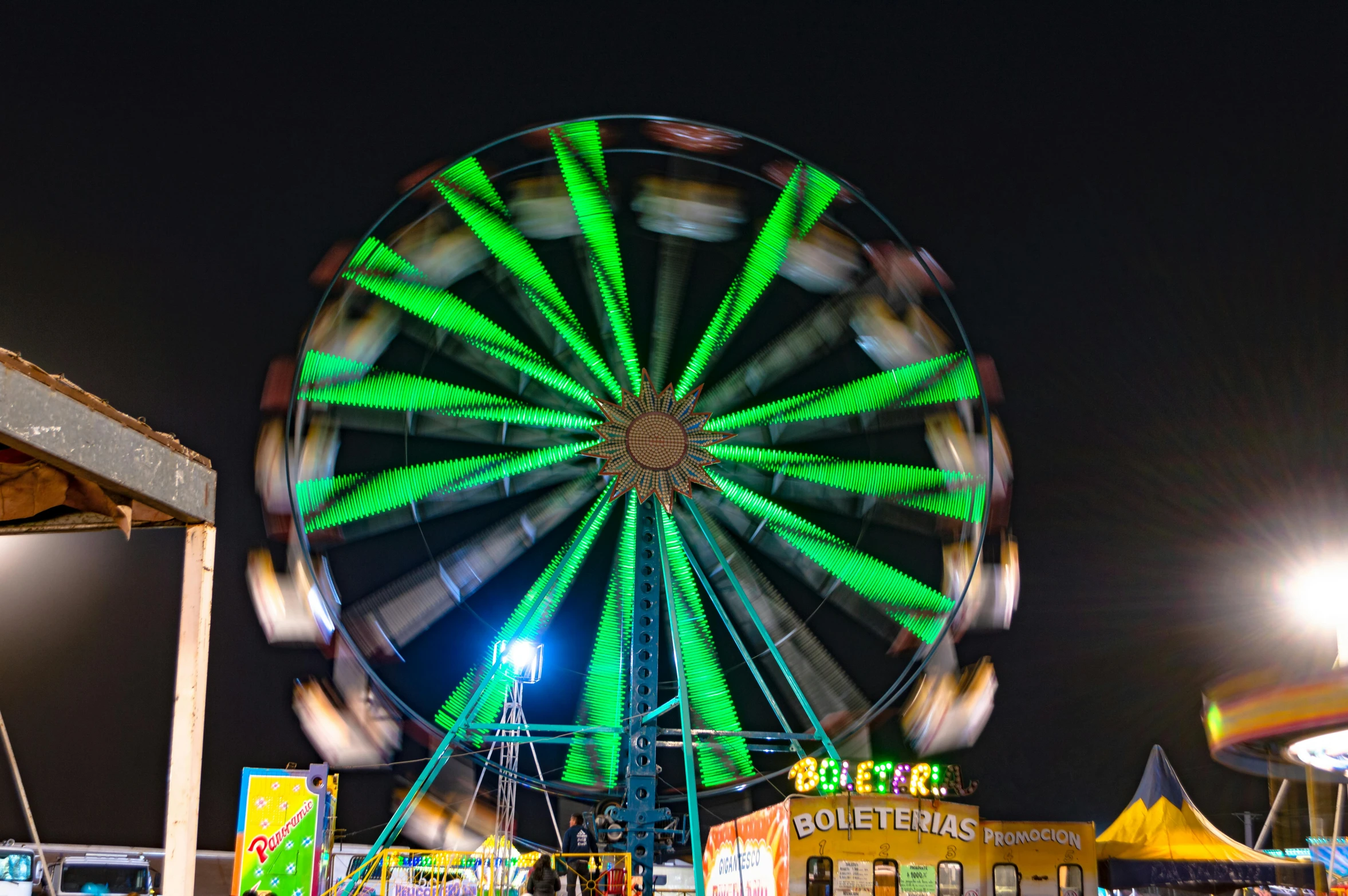 there is a very tall ferris wheel at the park