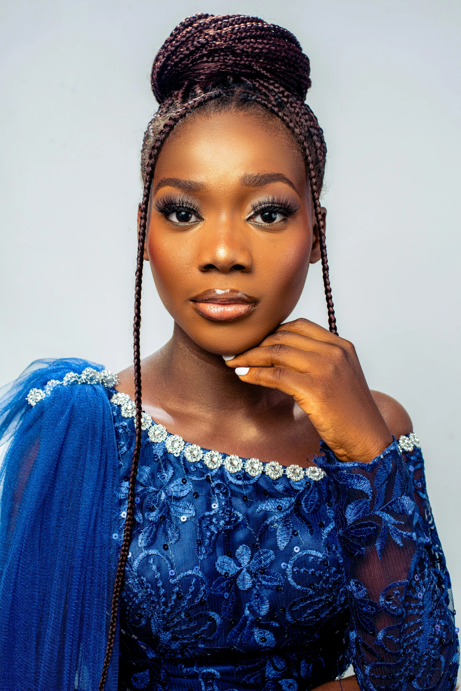 a woman posing for a picture wearing a blue dress