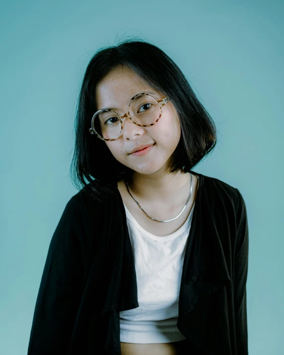 a beautiful young woman wearing glasses looking straight ahead