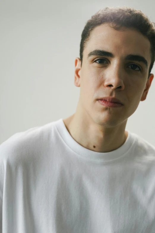 man wearing white shirt holding a knife in his hand