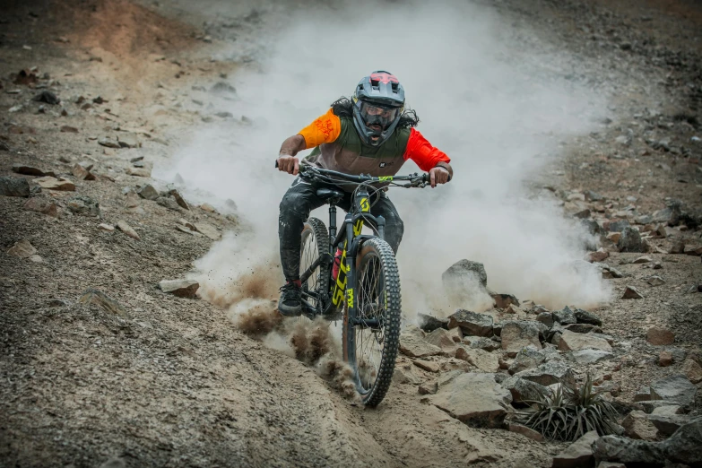 a person on a bike riding in the dirt