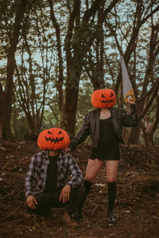 two people in halloween costumes standing behind a knife
