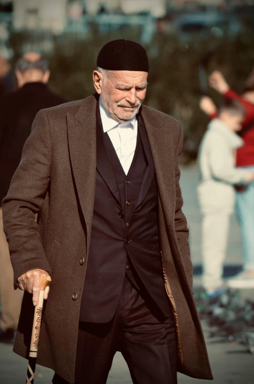 man walking down the street holding an umbrella