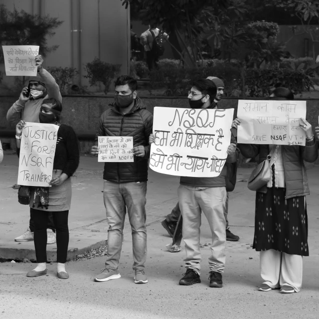 several people holding placards stand with signs