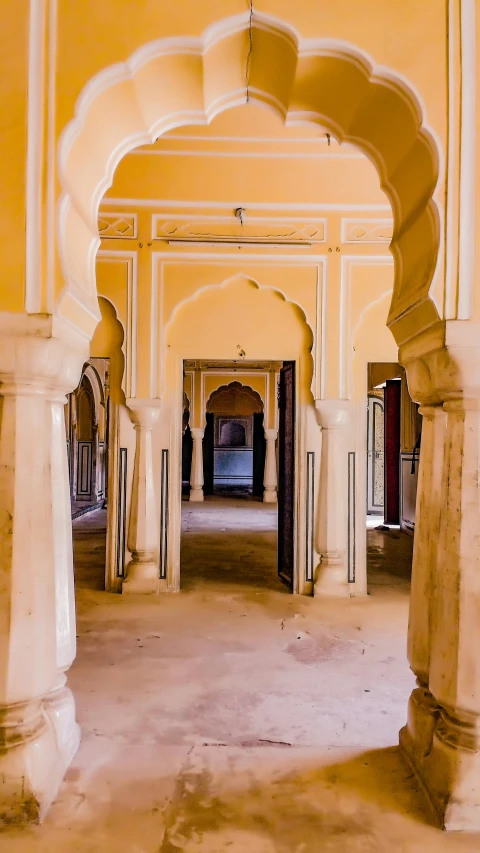 an archway is opening to a corridor with arches