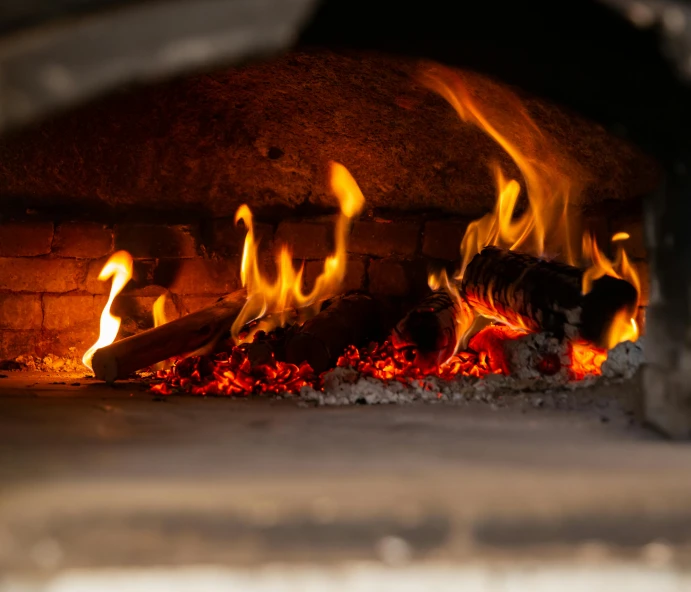 there is fire blazing in the brick oven