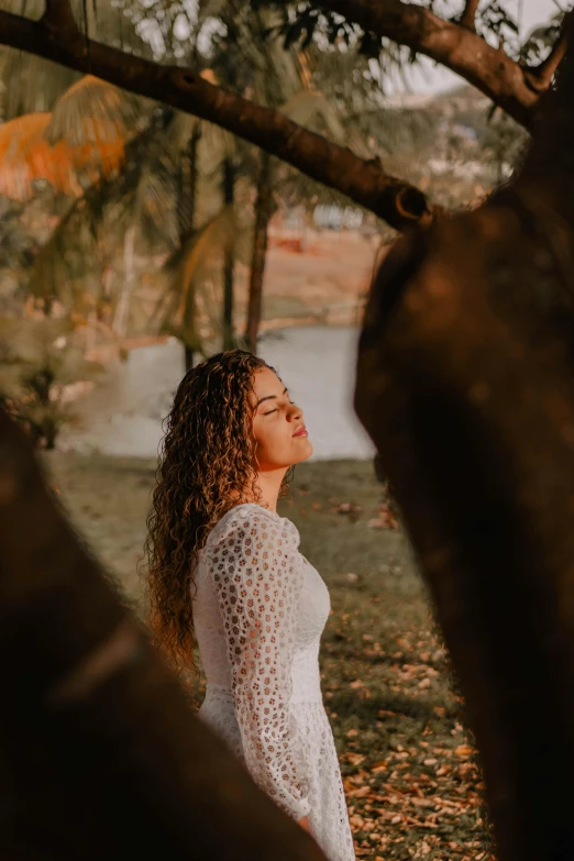 the woman is wearing white in the woods