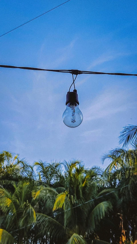 an old hanging light is on a power line