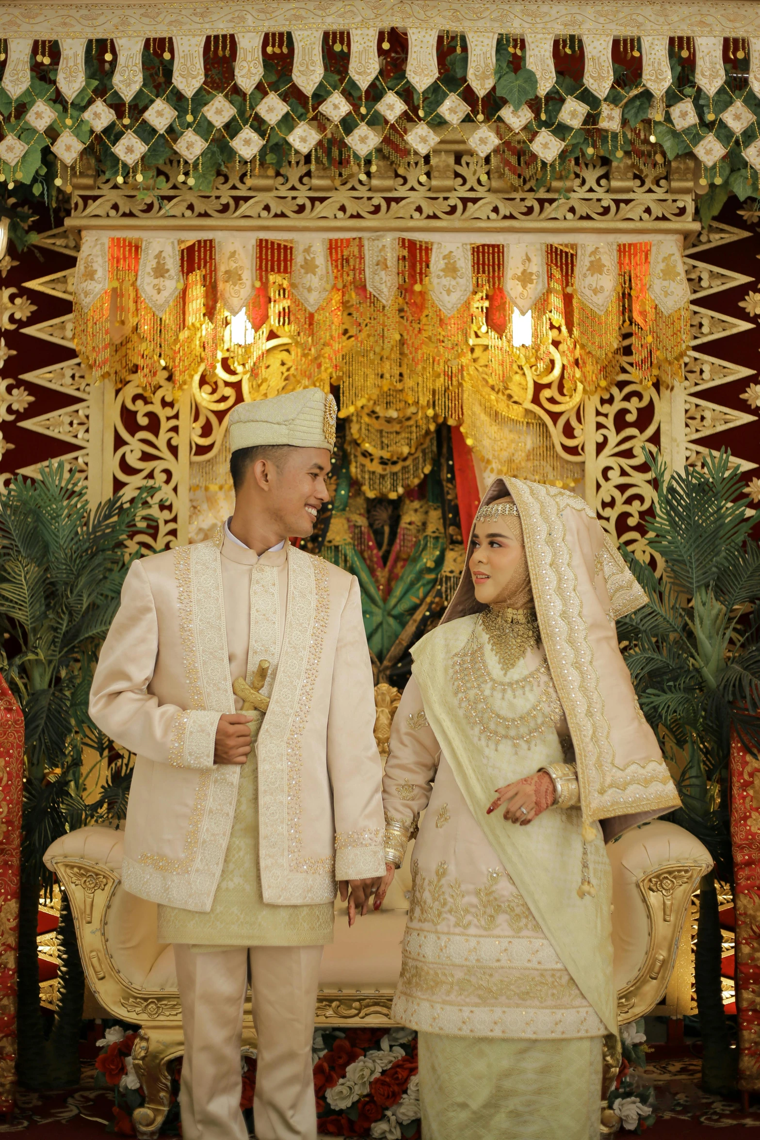 a young man and woman dressed in traditional indian attire