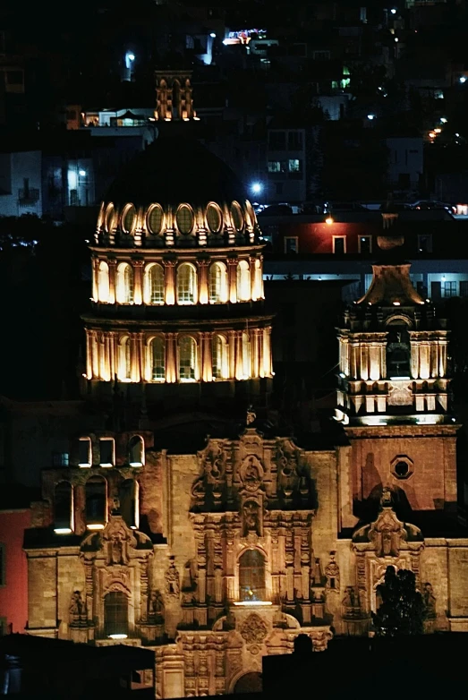 a dark city skyline at night, including some of the buildings lit up