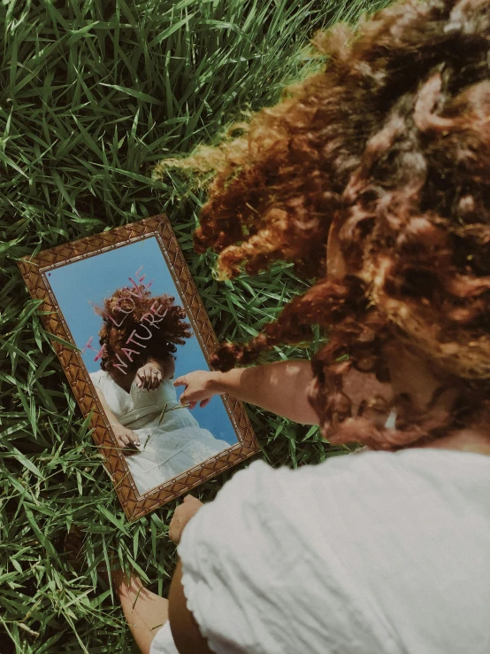 a woman laying on grass with an odd po