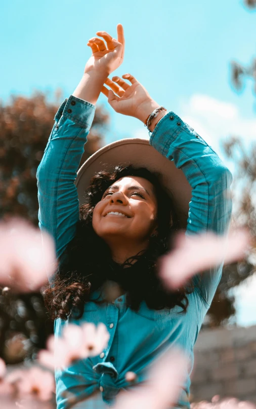 a woman wearing a hat and holding up a piece of bread