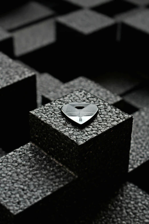 a silver object is positioned over gray cubes