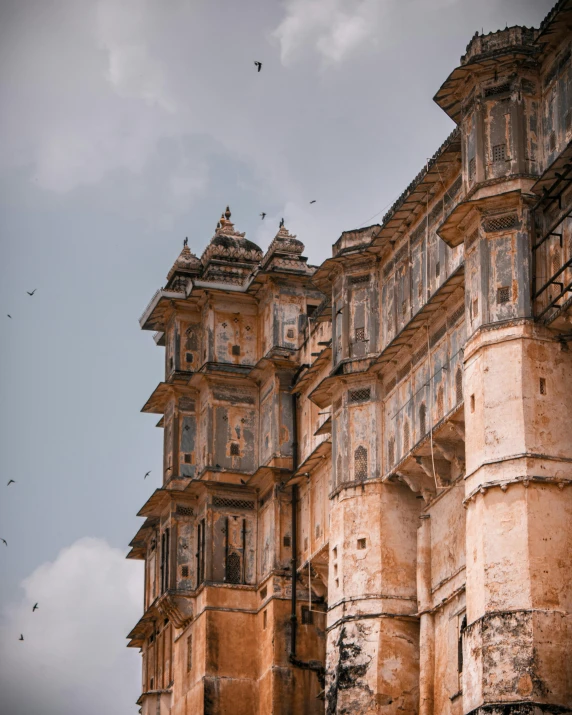 several birds fly high over old buildings with ed paint