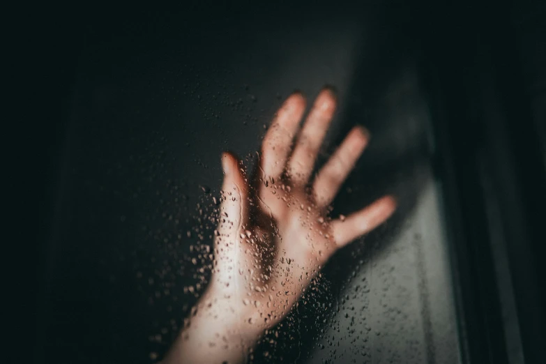 the hands are covered with water outside on a dark day