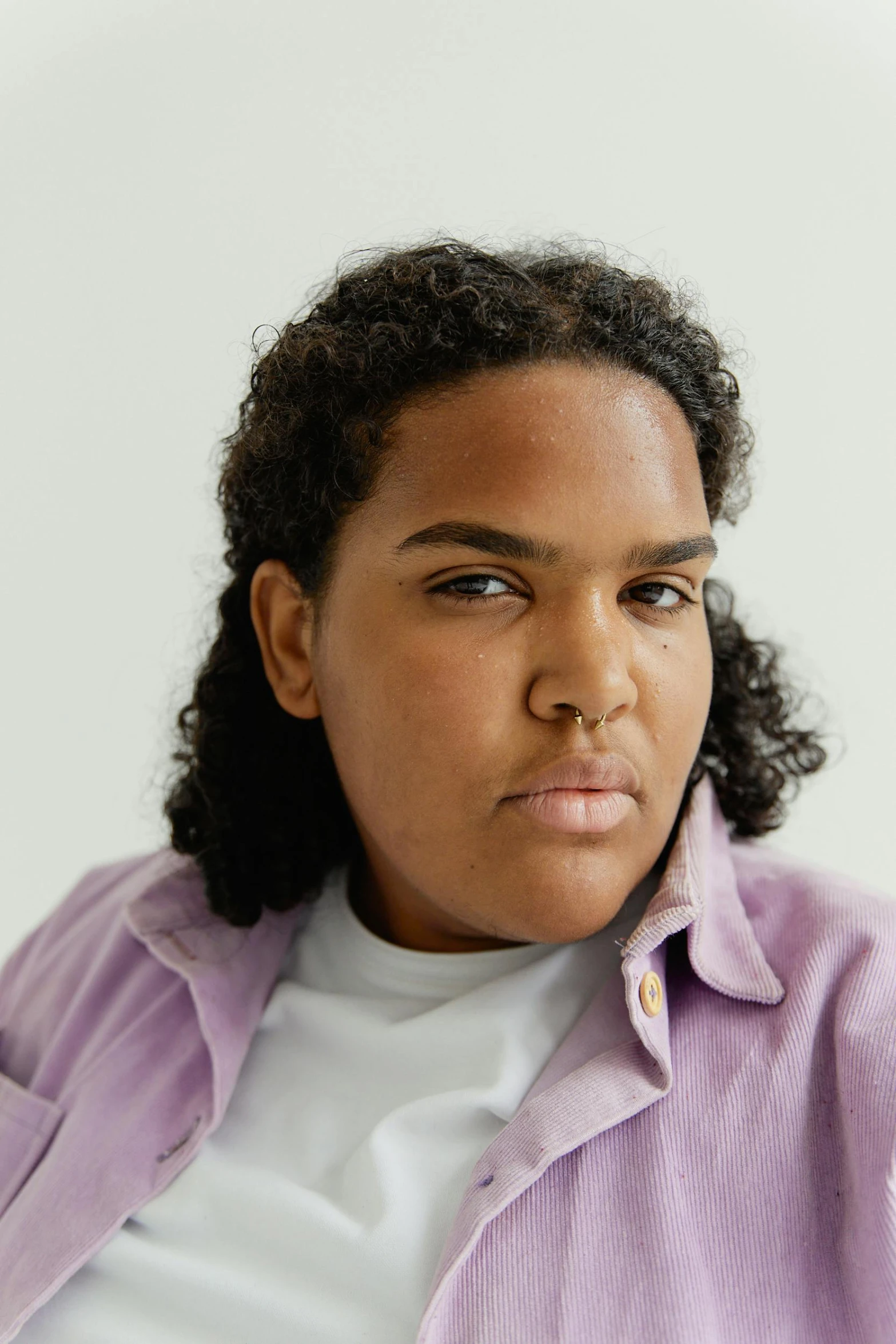 a black female with short hair in a purple shirt