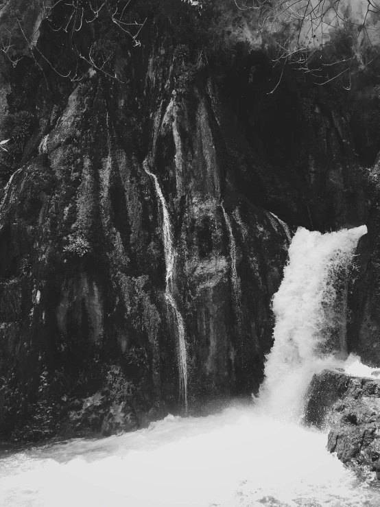 a waterfall in a wooded area with rocks