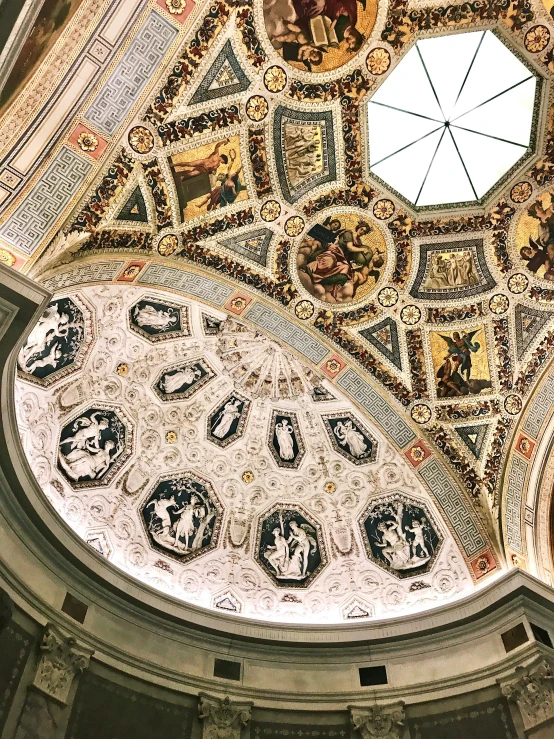 the ceiling of a building with many designs on it