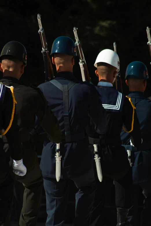 a group of people in uniform standing with guns