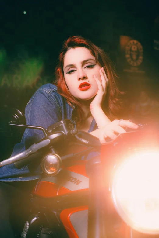 a beautiful young woman sitting on top of a motorcycle